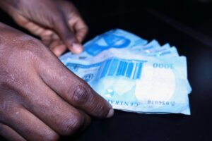 man holding naira notes