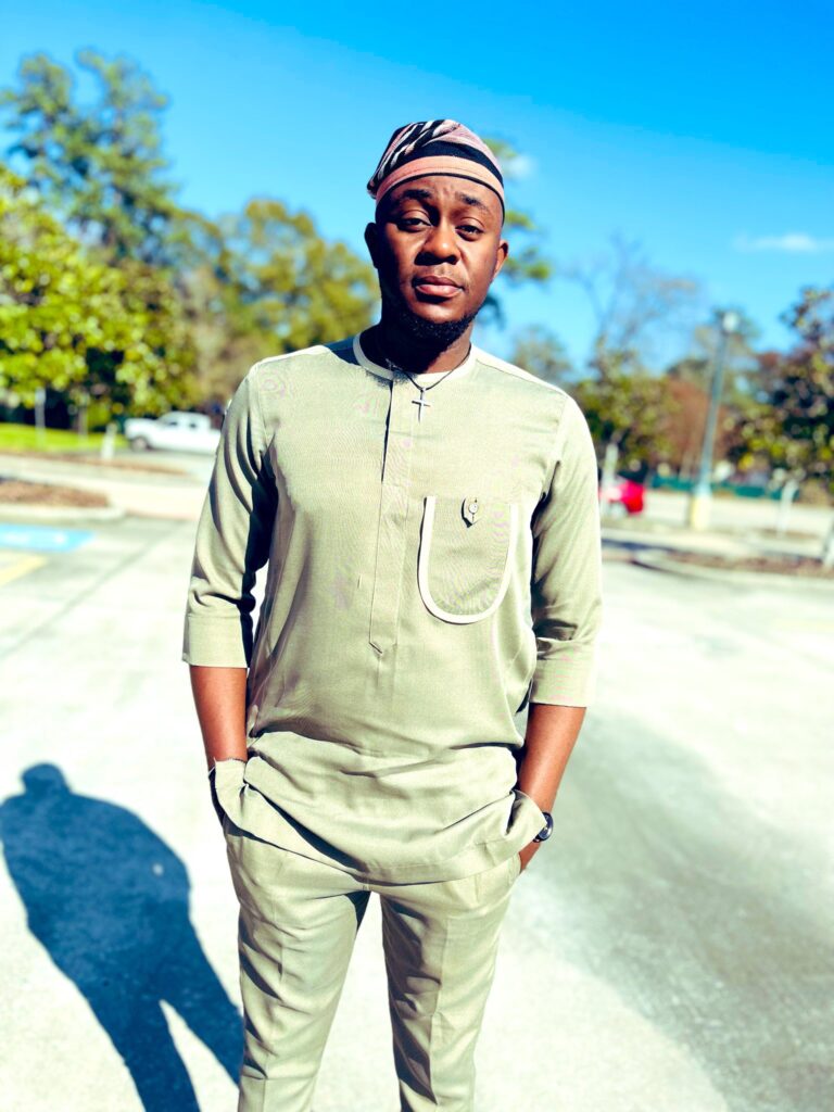 Balogun Kolawole Nathan wearing a Nigerian attire with cap