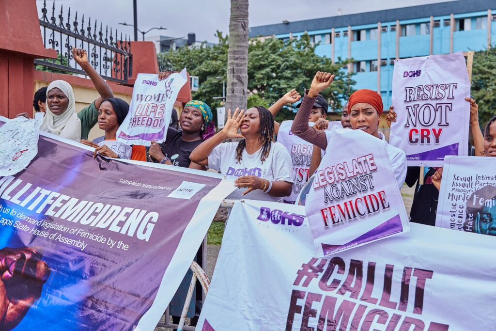 Nigerian feminists holding various banners with call to actions such as "Legislate femicide," call on Lagos State lawmakers to pass a bill against male murder of women