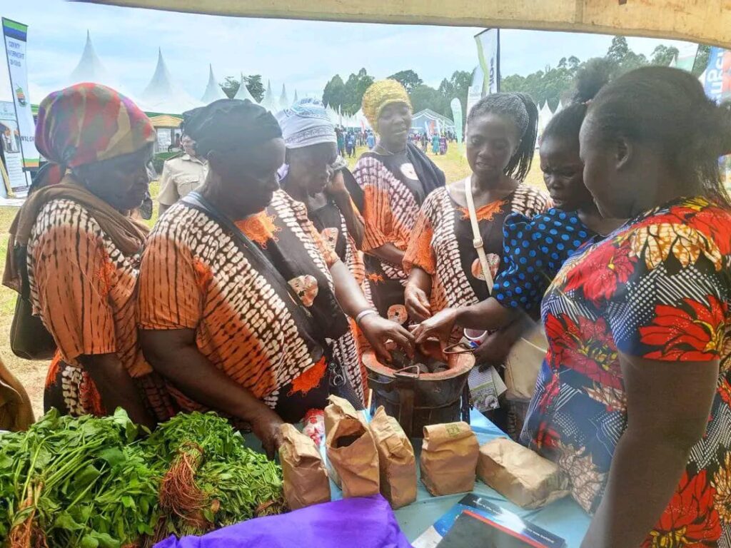 A group of Kenyan women in their traditional attire molding pottery