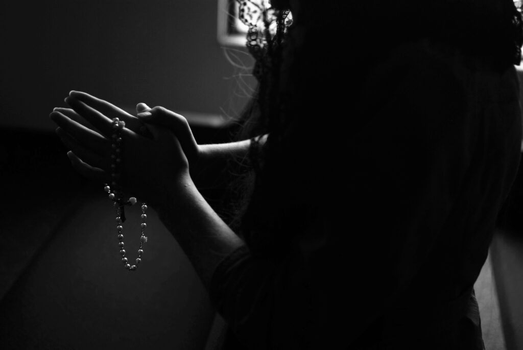 A lady praying with rosary