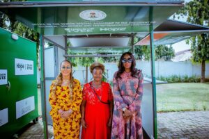 L-R: Former Minister of Women Affairs - Barrister Uju Kennedy-Ohanenye, Eucharia Okpalannadi, and Senior Special Assistant to the President on Technical, Vocational, and Entrepreneurship Education (TVEE) - Abiola Arogundade in front of the solar kiosk gifted to Eucharia.