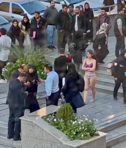 Caption: An image captured from the footage of Ahoo Daryaei protesting in her underwear.