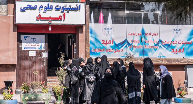 Afghan female health studies students gather outside the Omid Institute of Health Sciences in Kabul on December 3, 2024.