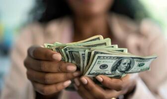 Black woman holding money.