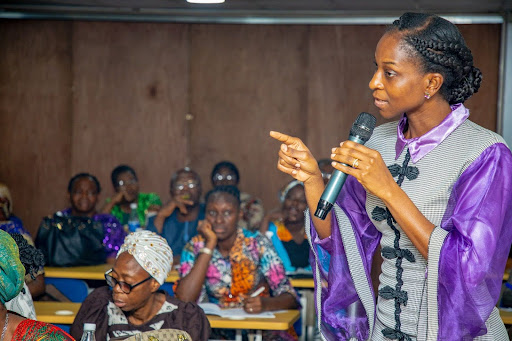 Ms Titilola Vivour-Adeniyi with a microphone close to her lips speaking.