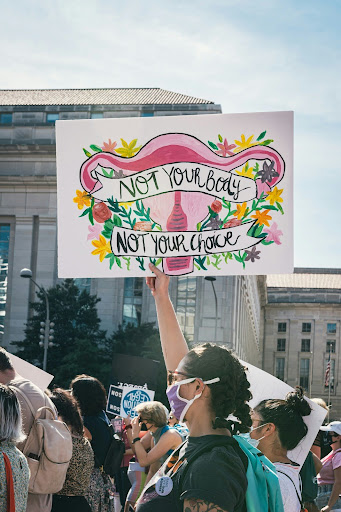 A woman holding a signboard