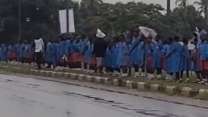 A screenshot from a video of the school children in the rain.