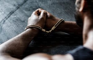 Handcuffed hands. Photo credit: Curated lifestyle on Unsplash