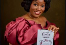 Chinwe Enyinna with her debut novel, My Garden of Thorny Roses  Photo credit: Chinwe's IG