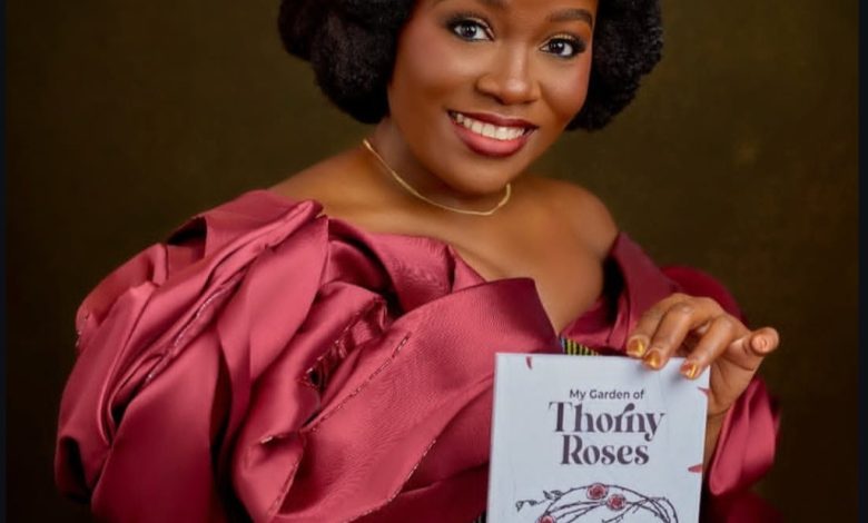 Chinwe Enyinna with her debut novel, My Garden of Thorny Roses  Photo credit: Chinwe's IG